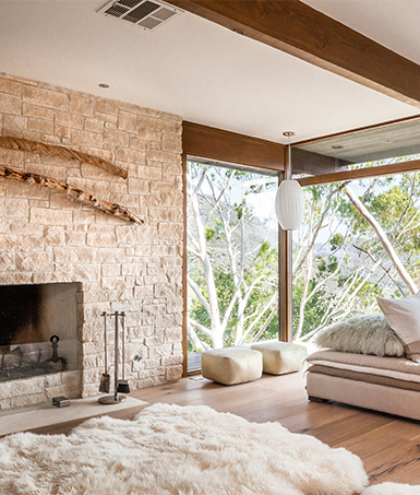 Spirit's Nest bedroom with beautiful floor to ceiling windows and a fireplace.